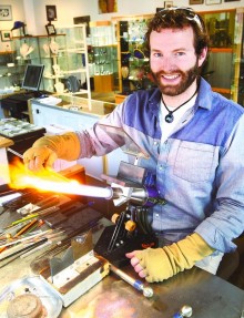 Dan Neff works on creating galaxy marbles Wednesday afternoon at his Lake Superior Art Glass shop in downtown Duluth. Neff is an Eagle Scout and credits Scouting for his business success. (Bob King / rking@duluthnews.com)