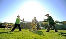 Scouts Alex Boeeze, left, and Noah Zeibdawi, right, Ottawa, Canada, get instruction from Peter Cecconi, of Troop 162, Lowville, on how to use a two-man saw during the International Boy Scouts encampment at Wellesley Island State Park on Saturday. AMANDA MORRISON WATERTOWN DAILY TIMES