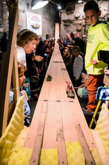 Flight to the finish: A crowd watches a pinewood derby final at The Boiler on Friday night. Photo by Stefano Giovannini.